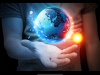 a man holding a globe in his hand